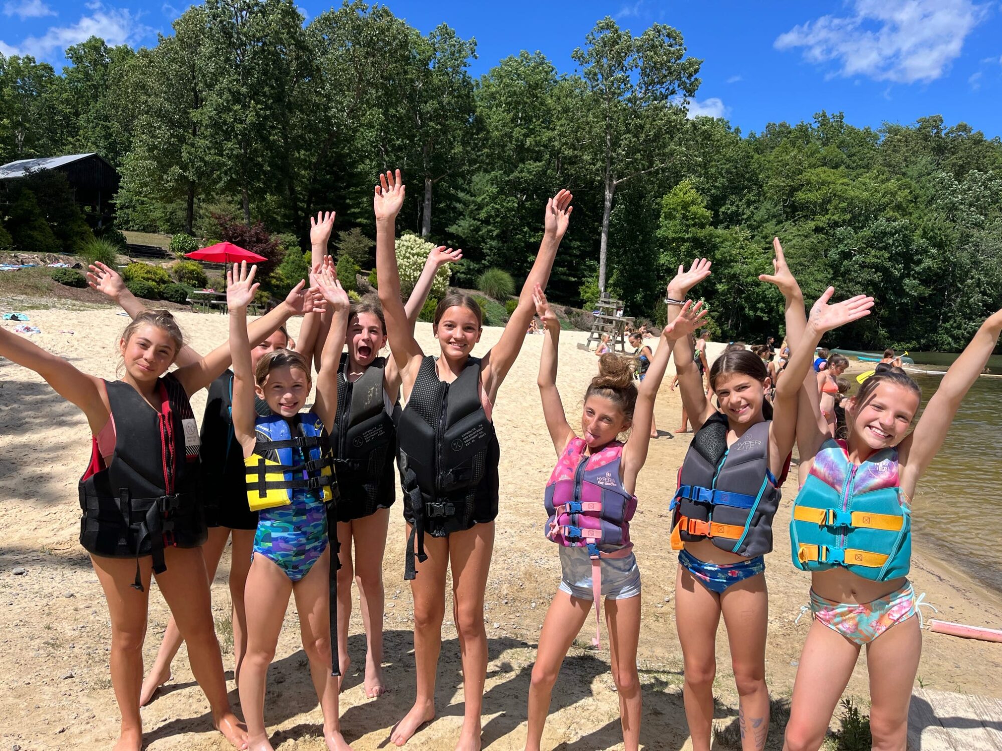 group of girls waving at camera on the Lake Frances beach